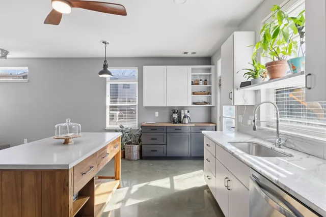 a kitchen with a sink stove and microwave