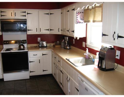2309 Haymaker Road Monroeville, PA 15146 - Photo 5 of 8 Kitchen. This 16 x 11 Laquered White Wood cabinetry and newly Tiled floor has a Refrigerator, Electric Stove, Microwave and Disposal. There is an abundance of cabinet space and enough room to make it an eat-in-kitchen. The laundry room is right off of the kitchen