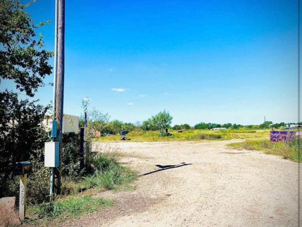 View of dirt / gravel road with a view of rural / pastoral area