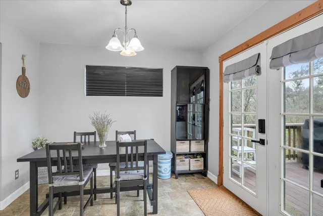 a view of a dining room with furniture and chandelier