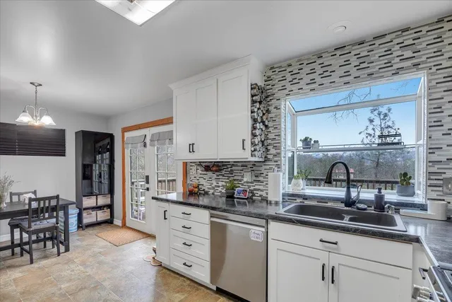 a kitchen with stainless steel appliances a sink and cabinets