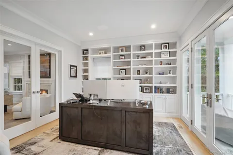 a living room with a large window and gym equipment