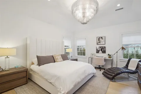 a bedroom with bed and a chair