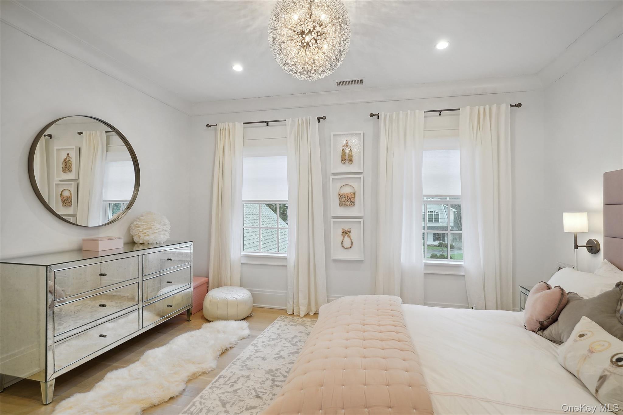 25 Hunt Place Rye, NY 10580 - Photo 18 of 44 a bedroom with a bed a mirror and a large window