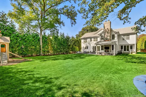 a front view of a house with a yard table and chairs