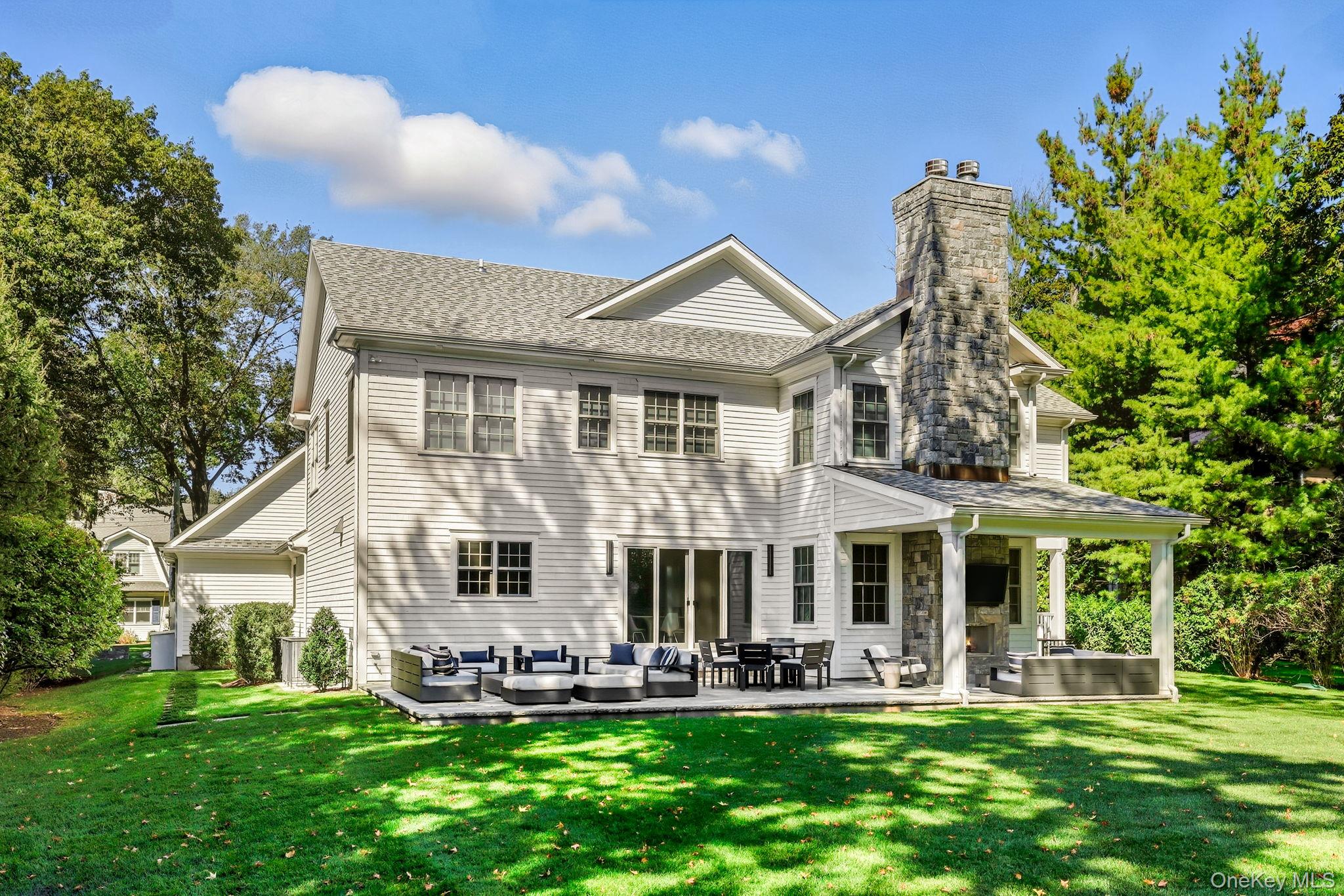 25 Hunt Place Rye, NY 10580 - Photo 34 of 44 a front view of a house with a yard and sitting area