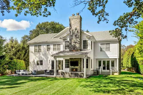 a view of a patio with table and chairs and potted plants
