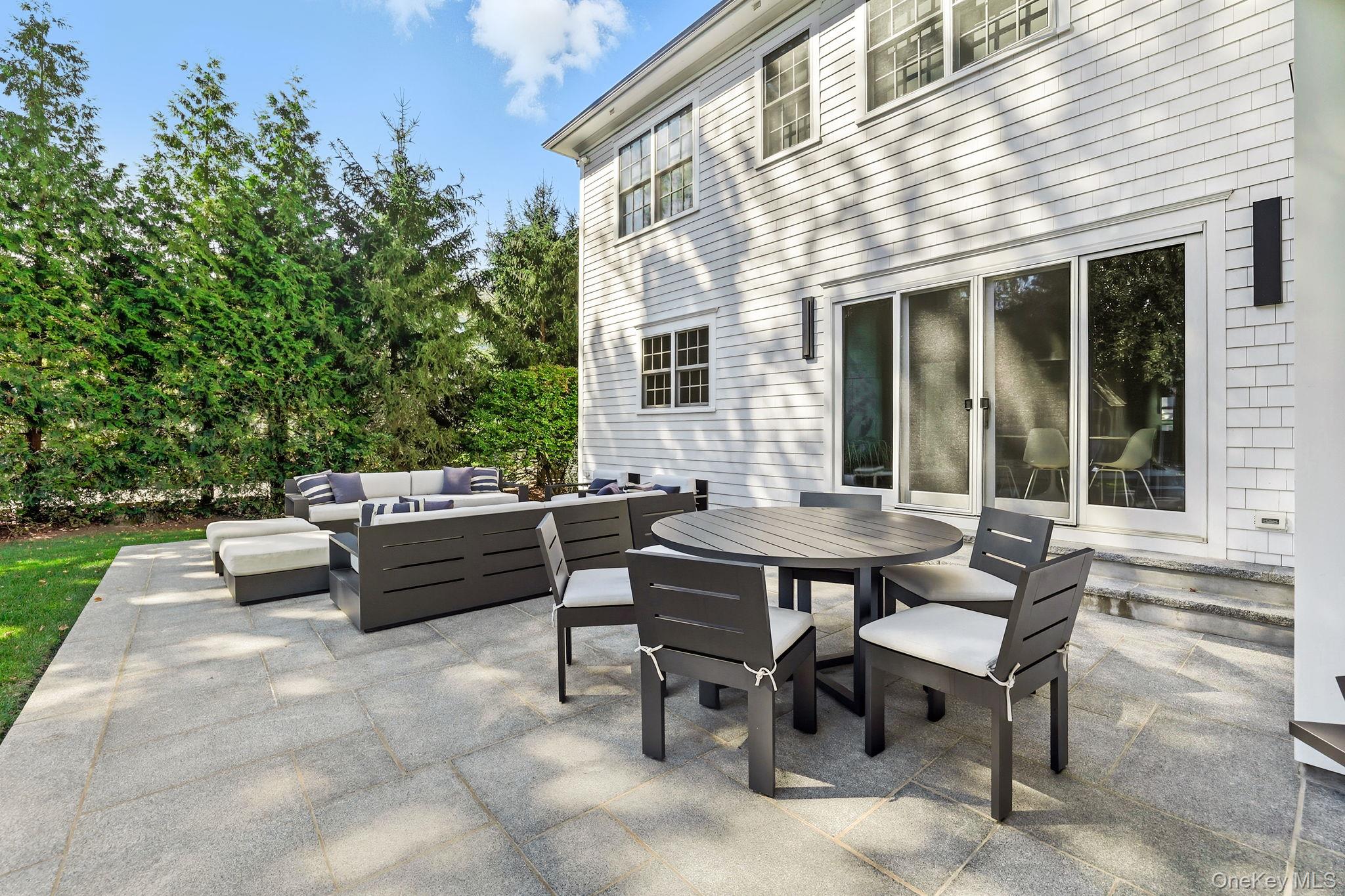 25 Hunt Place Rye, NY 10580 - Photo 36 of 44 a view of a patio with table and chairs and potted plants