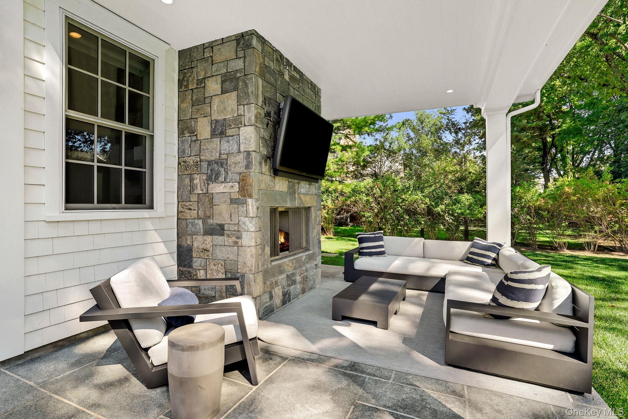 25 Hunt Place Rye, NY 10580 - Photo 37 of 44 a outdoor space with patio the couches and a fireplace with garden view