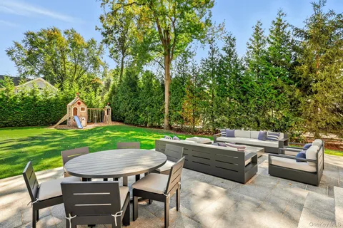 a view of a patio with couches chairs and a yard