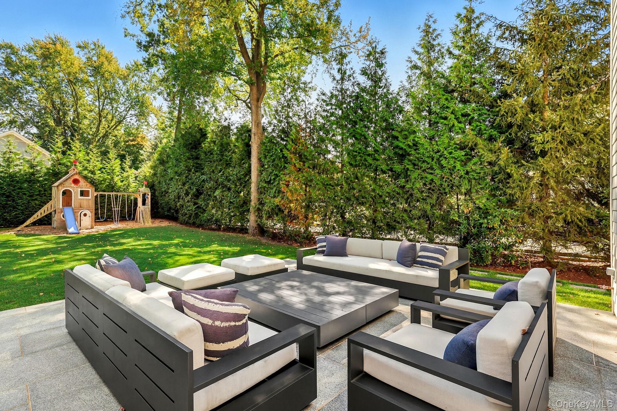 25 Hunt Place Rye, NY 10580 - Photo 39 of 44 a view of a patio with couches chairs and a yard
