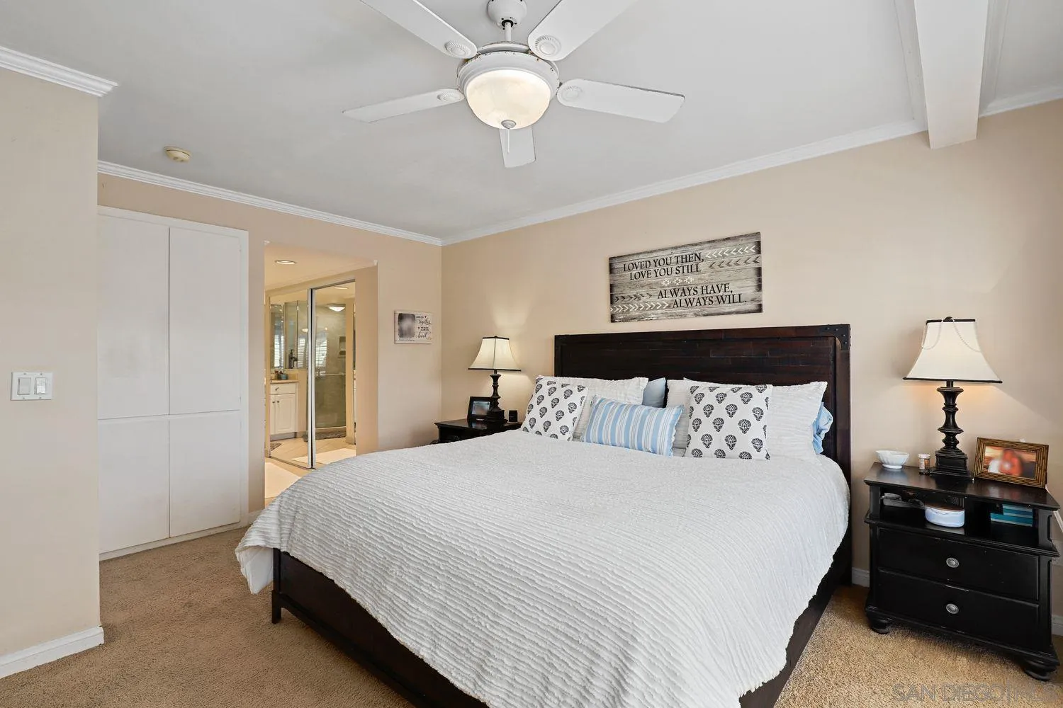 1818 Wilton Road Encinitas, CA 92024 - Photo 27 of 53 a bedroom with a bed and a chandelier