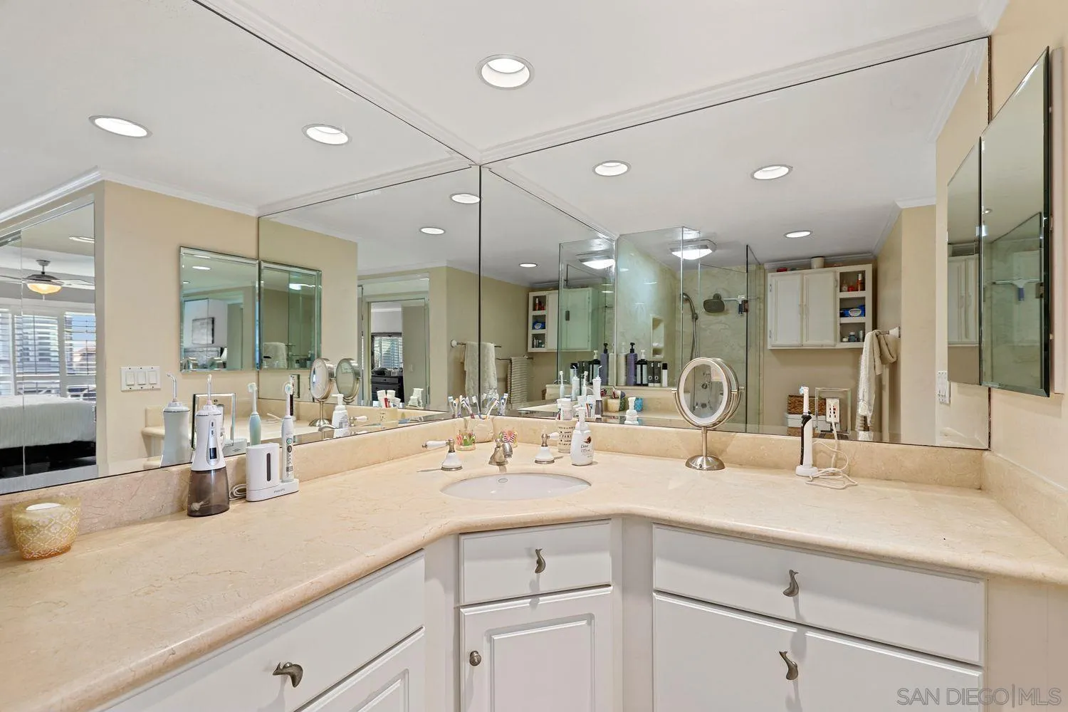 1818 Wilton Road Encinitas, CA 92024 - Photo 29 of 53 a bathroom with double vanity sinks a vanity a mirror and shower