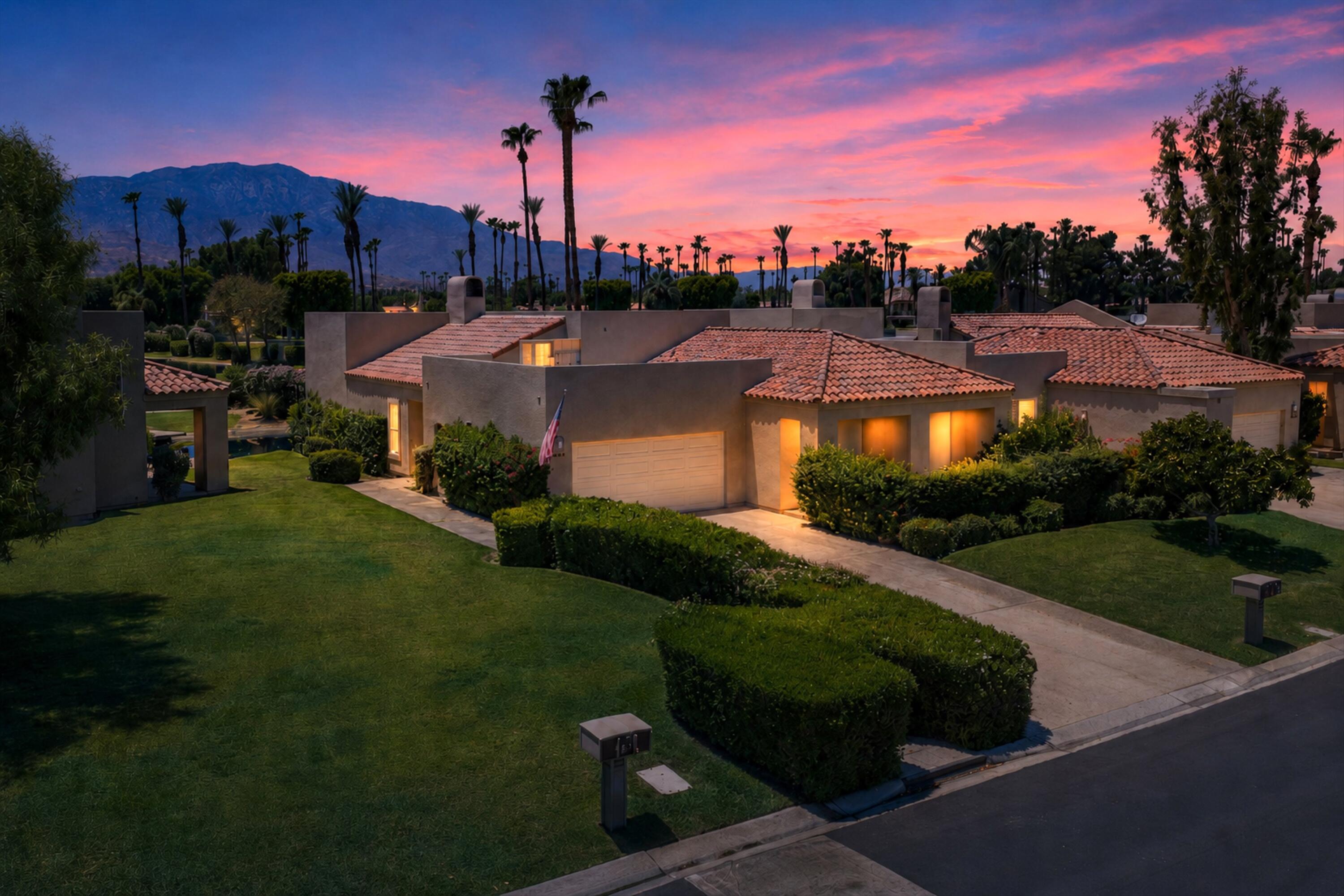 138 Lakeshore Drive Rancho Mirage, CA 92270 - Photo 24 of 30 a view of a house with a garden and a yard