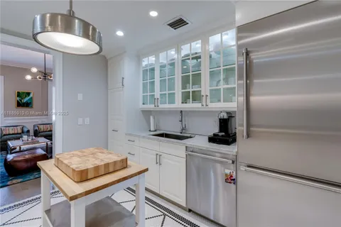 a kitchen with a cabinets and a refrigerator