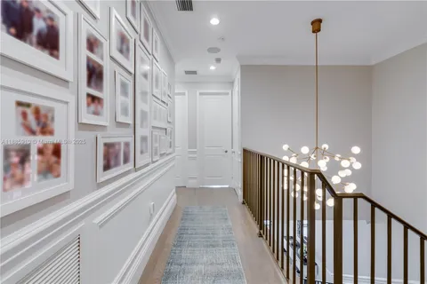 a spacious bedroom with a large bed and a chandelier