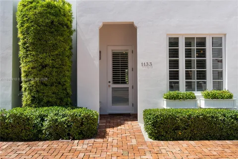 a room with lots of wooden furniture and a window
