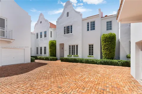 an aerial view of multiple houses with yard