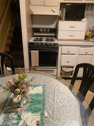 a stove top oven sitting inside of a kitchen