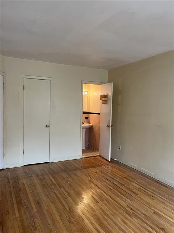 122 28th Avenue Brooklyn, NY 11214 - Photo 18 of 28 a view of empty room with wooden floor