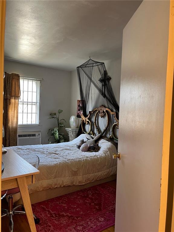 122 28th Avenue Brooklyn, NY 11214 - Photo 21 of 28 a bedroom with a bed and a mirror