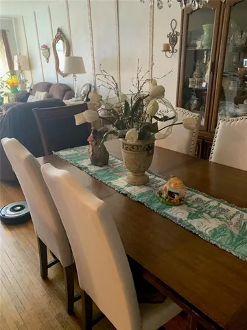 a dining room with furniture and wooden floor