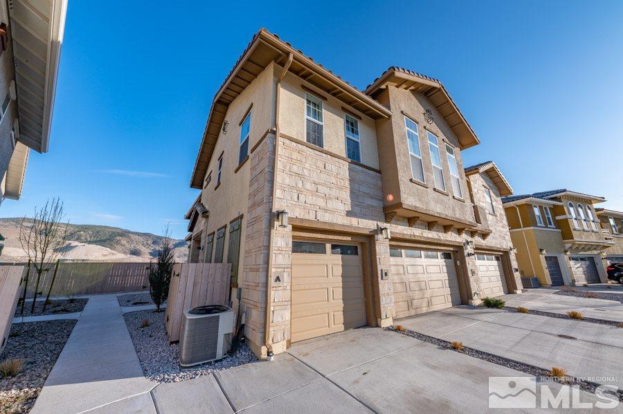 1860 Dark Horse Road, Unit A Reno, NV 89521 - Photo 3 of 15 a front view of a house with a garage