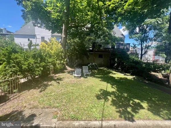 a backyard of a house with yard and trampoline