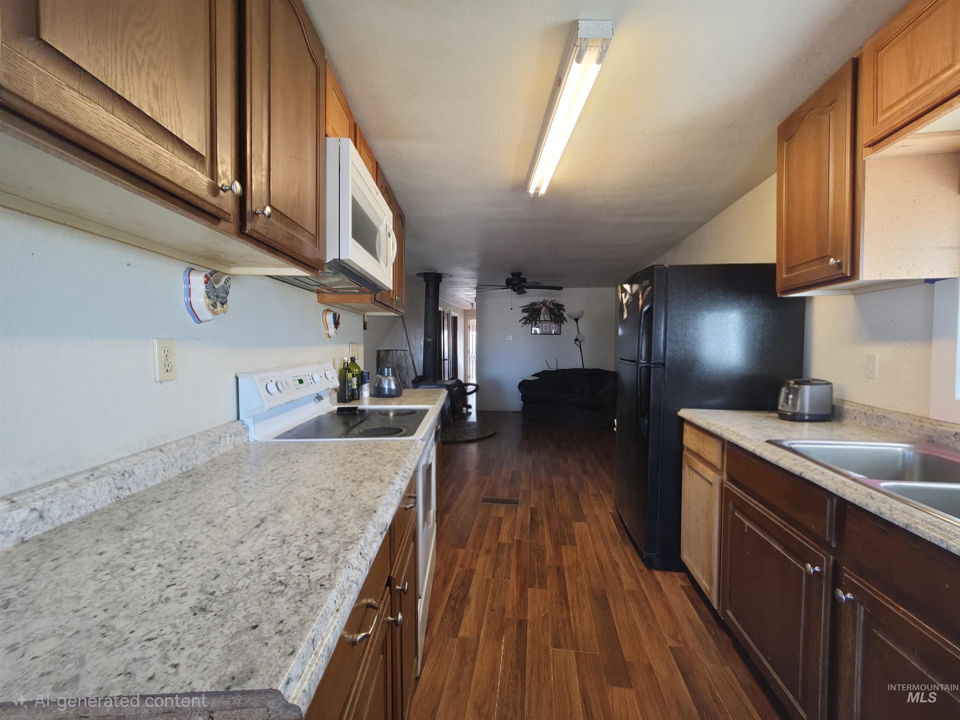 236 West 600 North Rupert, ID 83350 - Photo 12 of 29 Kitchen with white appliances, dark wood-type flooring, and wood finish cabinetry