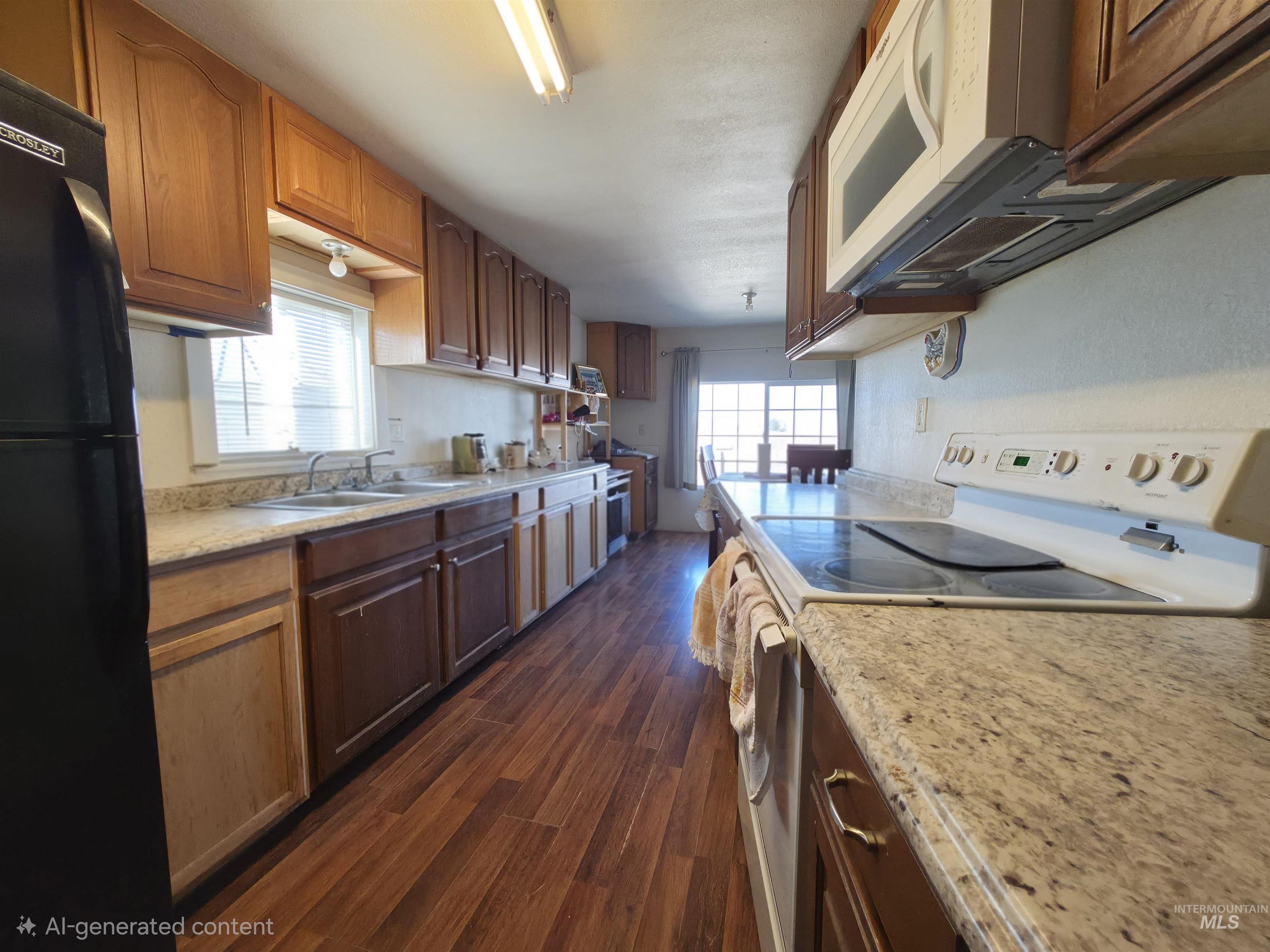 236 West 600 North Rupert, ID 83350 - Photo 17 of 29 Kitchen with white appliances, dark wood finished floors, and wood finish cabinets