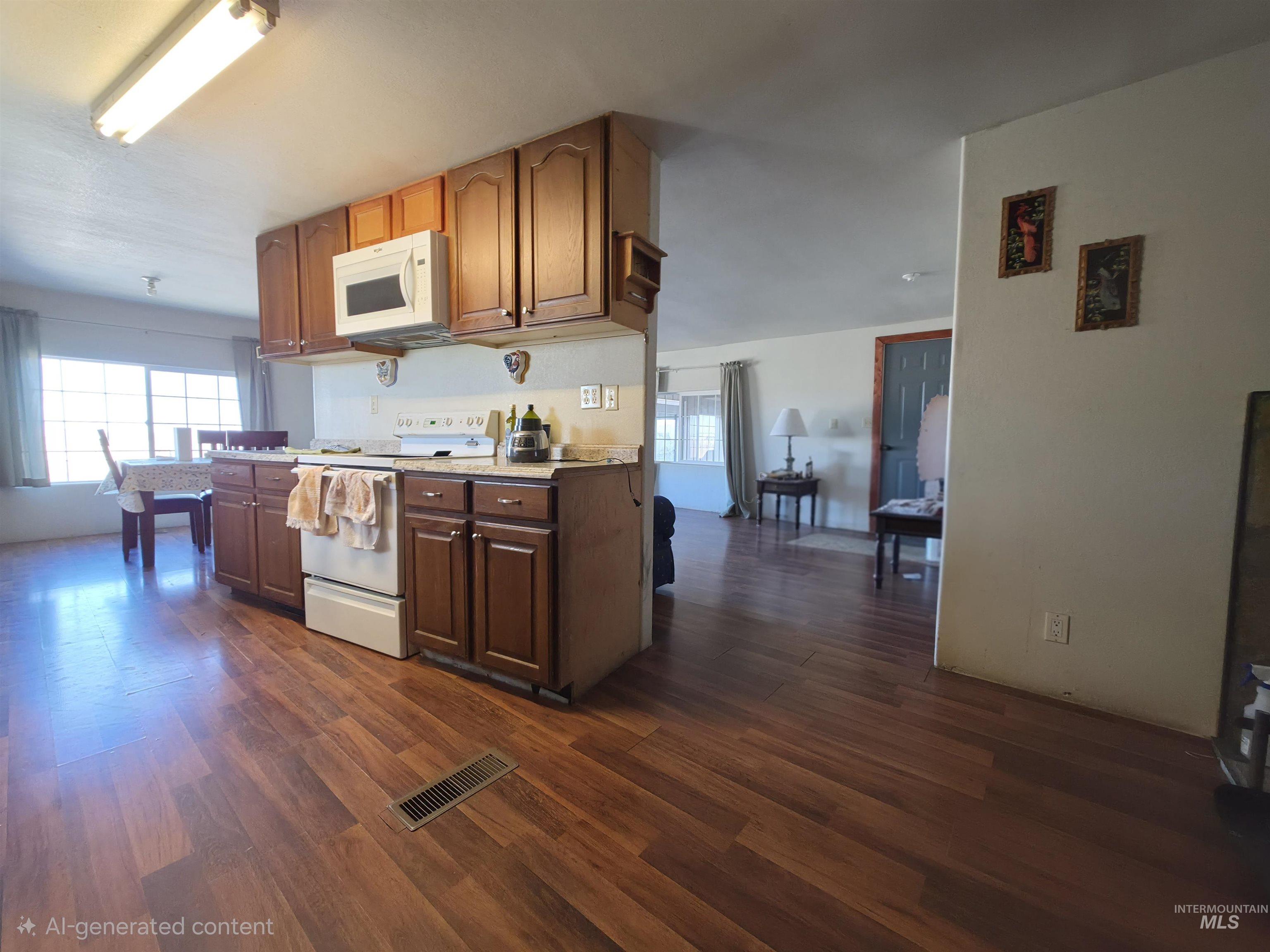 236 West 600 North Rupert, ID 83350 - Photo 18 of 29 Kitchen with white appliances, plenty of natural light, and dark wood-style floors