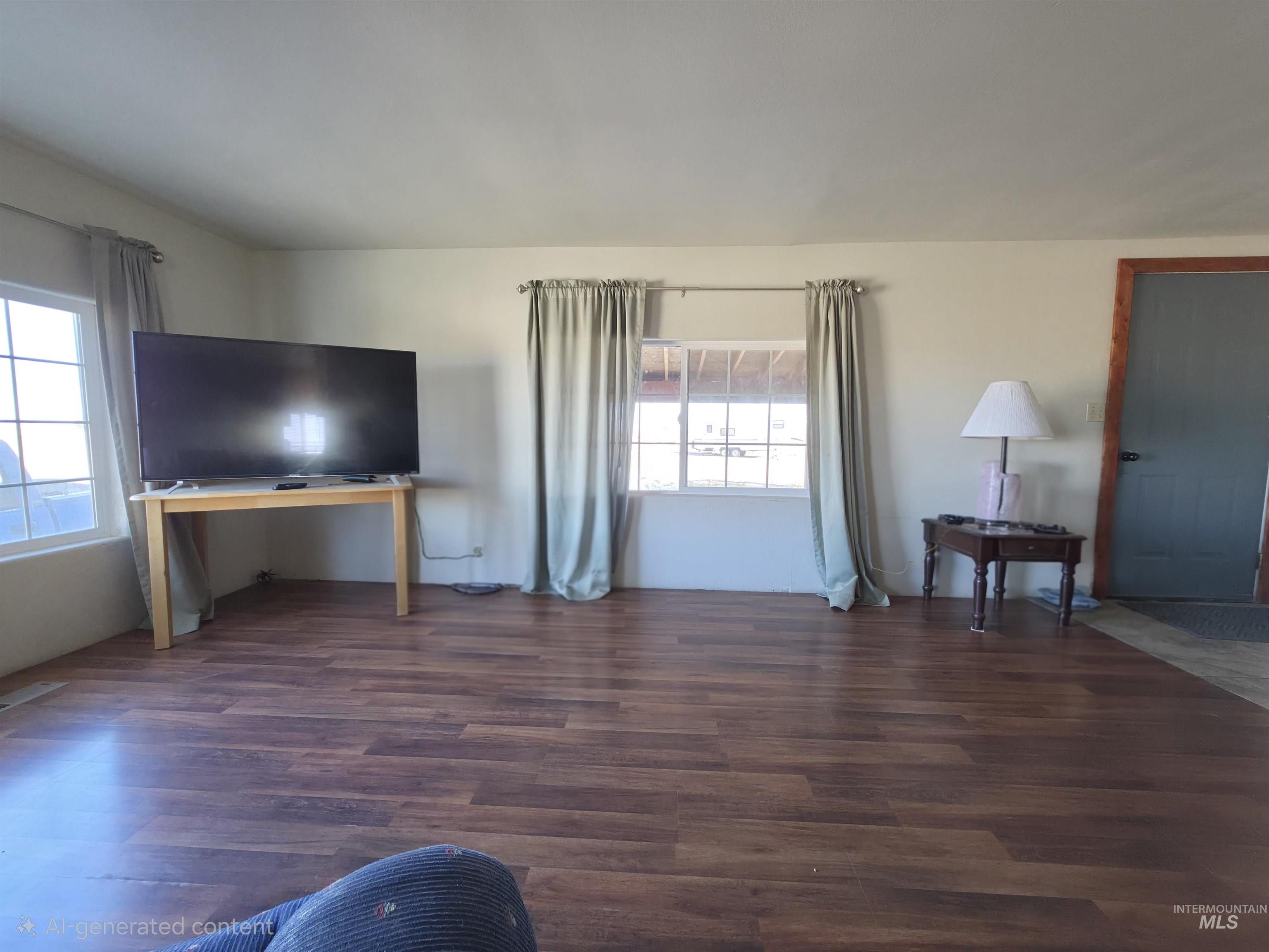 236 West 600 North Rupert, ID 83350 - Photo 10 of 29 Unfurnished living room featuring dark wood-type flooring