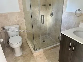 a bathroom with a shower and a toilet
