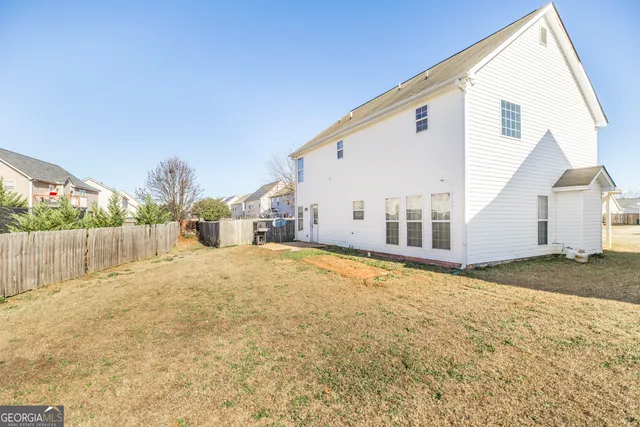 a view of a house with backyard and road