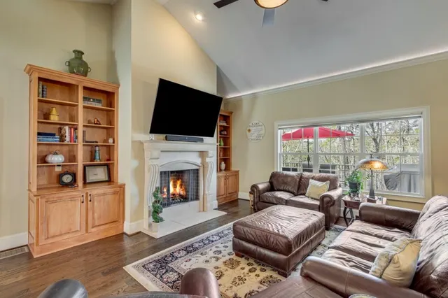 a living room with furniture fireplace and flat screen tv