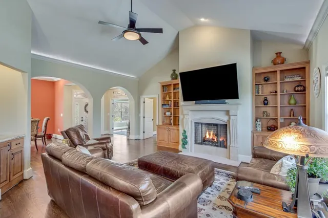 a living room with furniture a fireplace and a flat screen tv