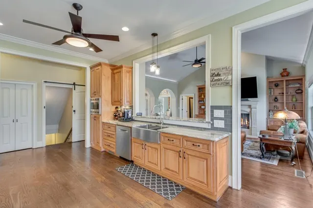 a open kitchen with white cabinets and stainless steel appliances