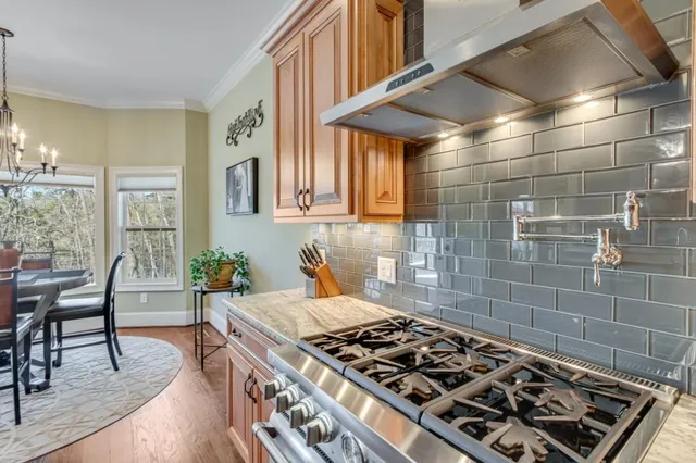 a stove top oven sitting inside of a kitchen
