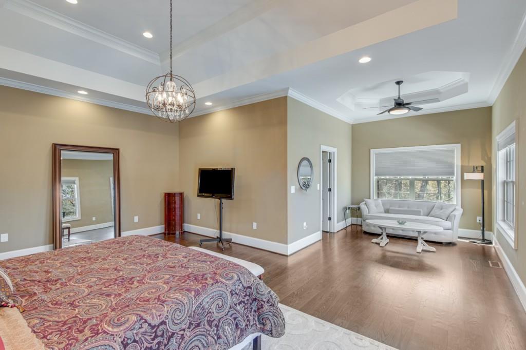 2152 Silver Circle Gainesville, GA 30501 - Photo 20 of 46 a spacious bedroom with a bed and a chandelier
