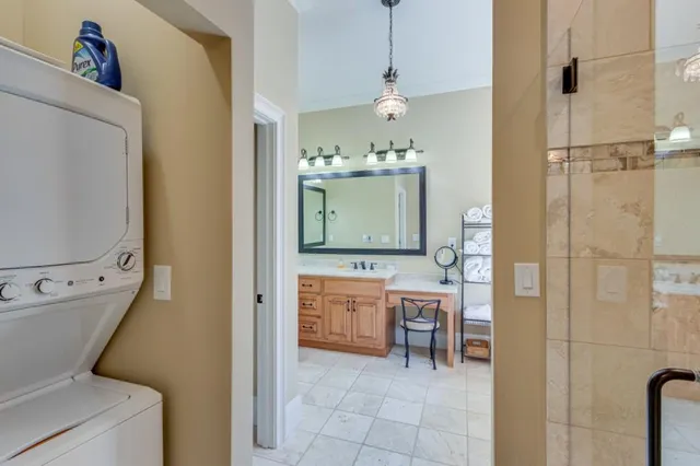 a bathroom with a granite countertop sink mirror vanity and toilet