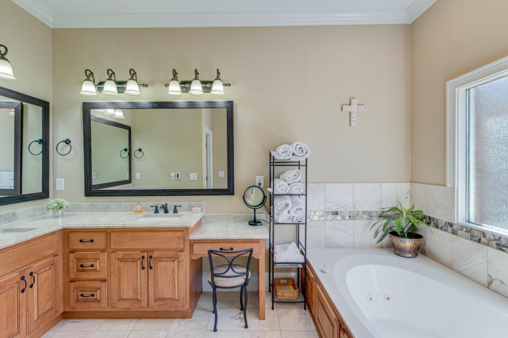 2152 Silver Circle Gainesville, GA 30501 - Photo 22 of 46 a bathroom with a granite countertop sink a mirror and bathtub