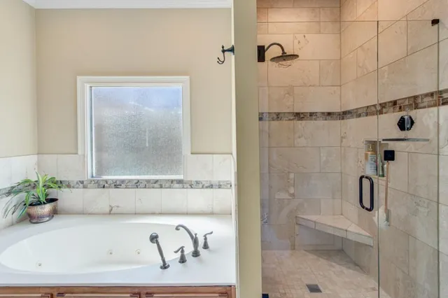 a bathroom with a bathtub and shower