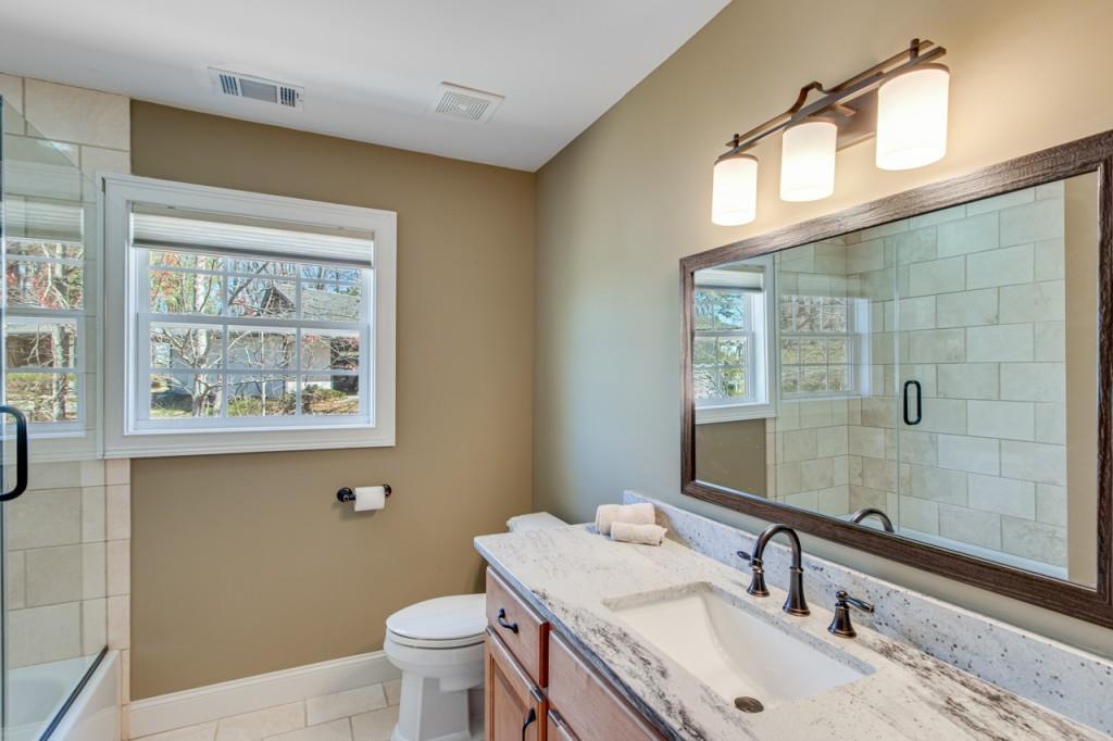 2152 Silver Circle Gainesville, GA 30501 - Photo 30 of 46 a bathroom with a sink a toilet and mirror