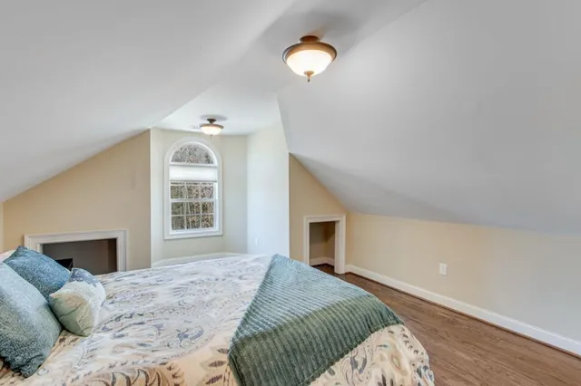 a spacious bedroom with a bed and a window