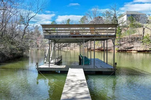 a view of swimming pool with outdoor seating and lake view