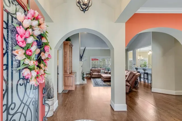 a dining room with furniture entryway and wooden floor