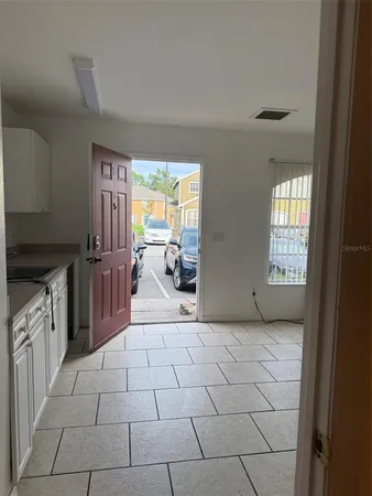 a view of a kitchen with furniture and staircase
