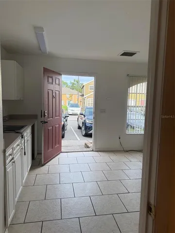 a view of a kitchen with furniture and staircase