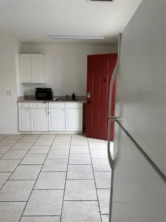 a kitchen with stainless steel appliances a refrigerator sink and cabinets