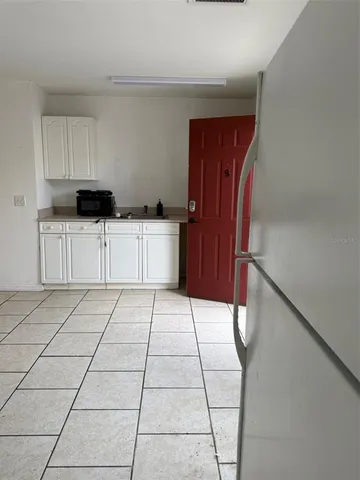 a kitchen with stainless steel appliances a refrigerator sink and cabinets
